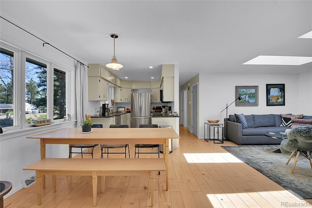 29858 Gigi Dr, Evergreen, CO 80439 - dining space featuring a skylight and light wood-type flooring