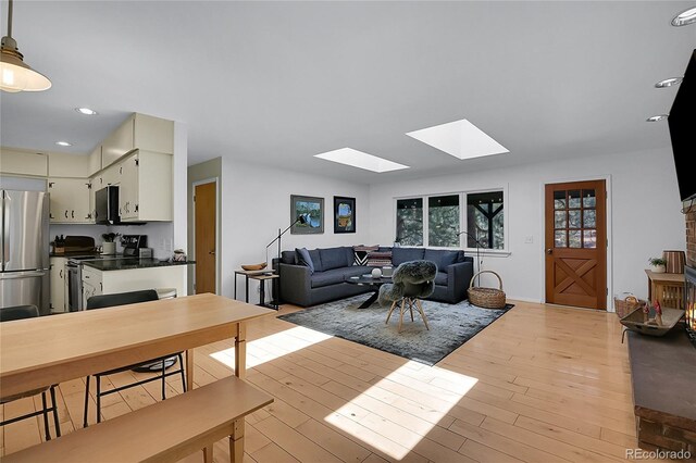 29858 Gigi Dr, Evergreen, CO 80439 - living room with a skylight, light wood-style flooring, and recessed lighting