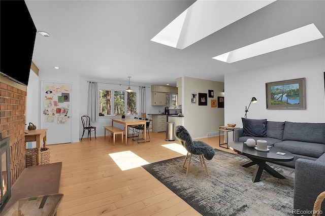 29858 Gigi Dr, Evergreen, CO 80439 - living room featuring light wood-style floors and a skylight