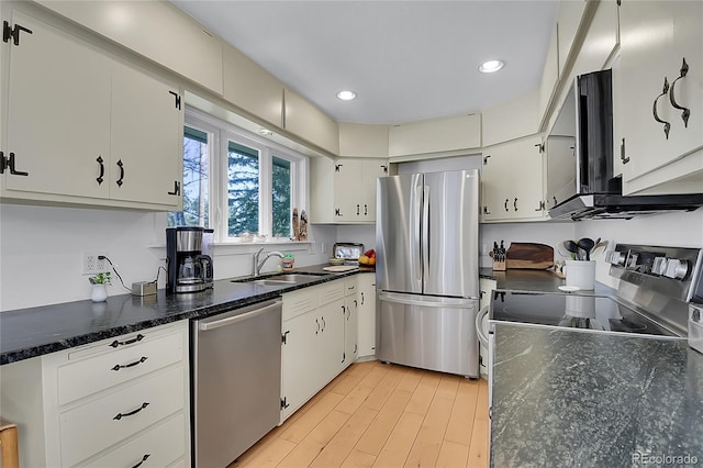 29858 Gigi Dr, Evergreen, CO 80439 - kitchen featuring appliances with stainless steel finishes, recessed lighting, light wood-type flooring, white cabinets, and dark stone countertops