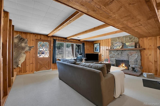 29858 Gigi Dr, Evergreen, CO 80439 - living area featuring a stone fireplace, carpet floors, wooden walls, and a wood ceiling with exposed beams