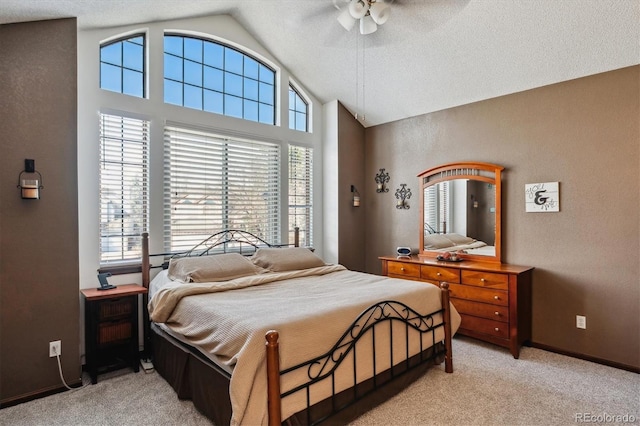 bedroom featuring multiple windows, light colored carpet, and ceiling fan