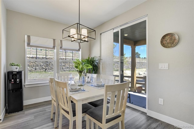16277 Talons Bluff Ln, Monument, CO 80132 - dining area with baseboards, plenty of natural light, and a chandelier