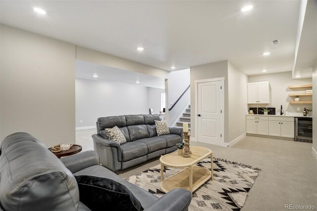 16277 Talons Bluff Ln, Monument, CO 80132 - living area with wine cooler, bar with sink, stairs, light colored carpet, and baseboards