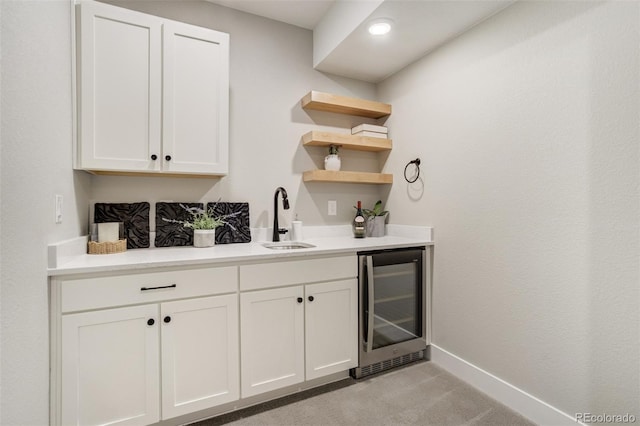 16277 Talons Bluff Ln, Monument, CO 80132 - bar featuring beverage cooler, a sink, light carpet, and baseboards