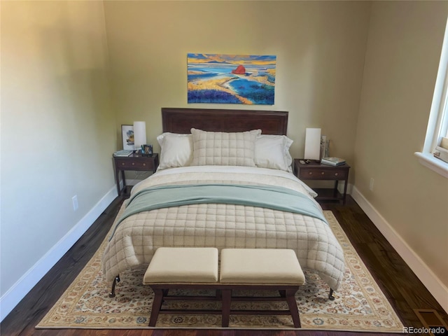 bedroom featuring baseboards and dark wood finished floors