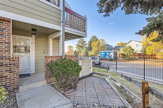 exterior space featuring fence and a balcony