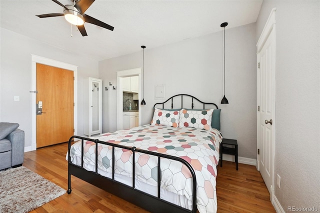 bedroom featuring hardwood / wood-style floors and ceiling fan