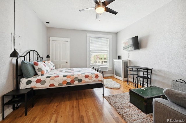 bedroom with ceiling fan and wood-type flooring