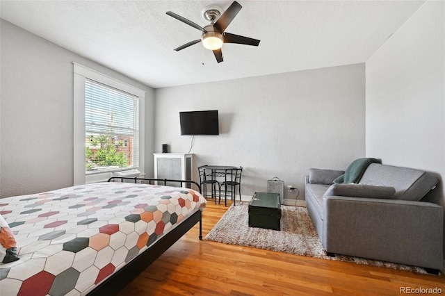 bedroom with hardwood / wood-style flooring and ceiling fan