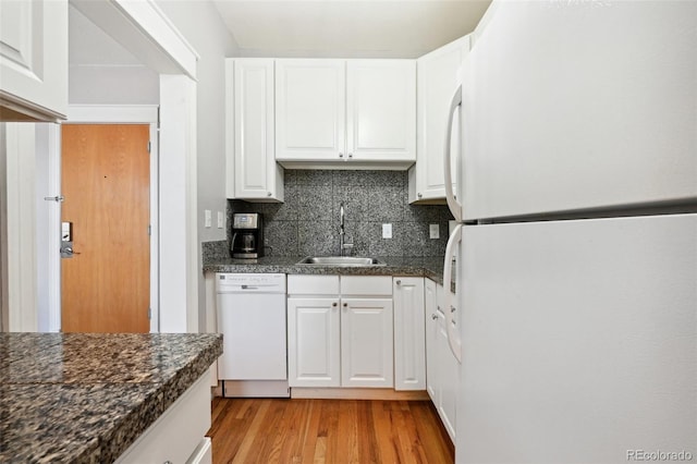 kitchen featuring white appliances, sink, tasteful backsplash, light hardwood / wood-style floors, and white cabinetry