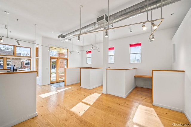 interior space featuring hanging light fixtures and light hardwood / wood-style flooring