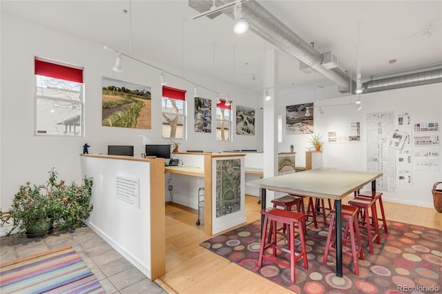 dining room featuring light hardwood / wood-style flooring and built in desk