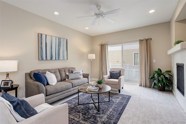 carpeted living room with ceiling fan