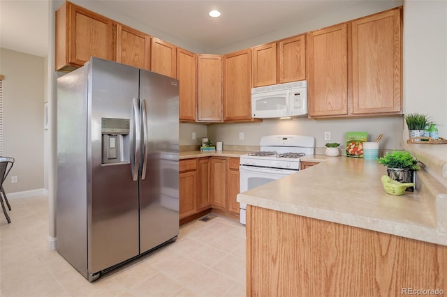 kitchen with white appliances and light brown cabinets