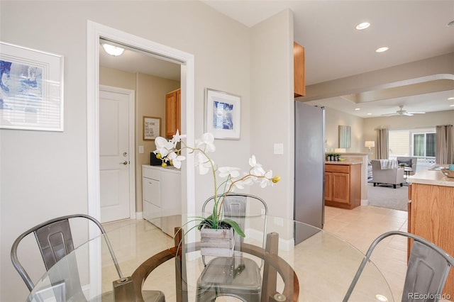 dining space with ceiling fan and light tile patterned floors