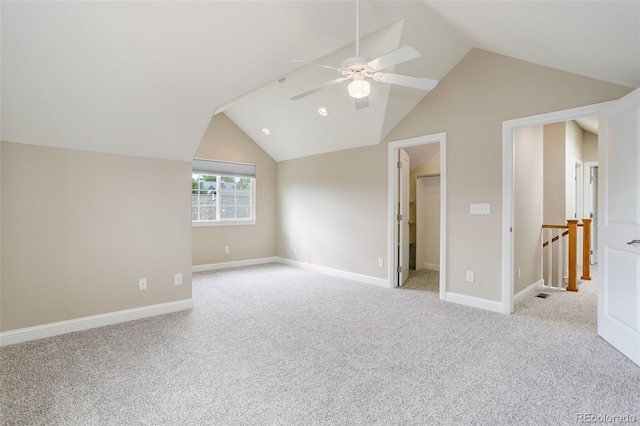 additional living space featuring lofted ceiling, light carpet, and ceiling fan