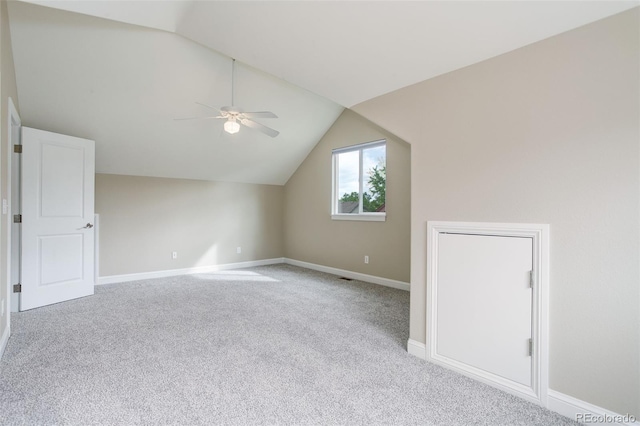 bonus room featuring ceiling fan, vaulted ceiling, and light carpet