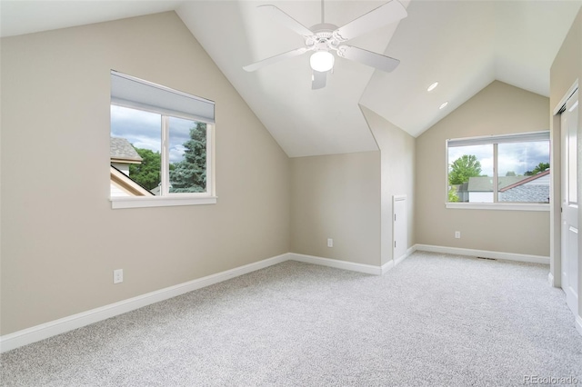 additional living space featuring lofted ceiling, light carpet, and ceiling fan