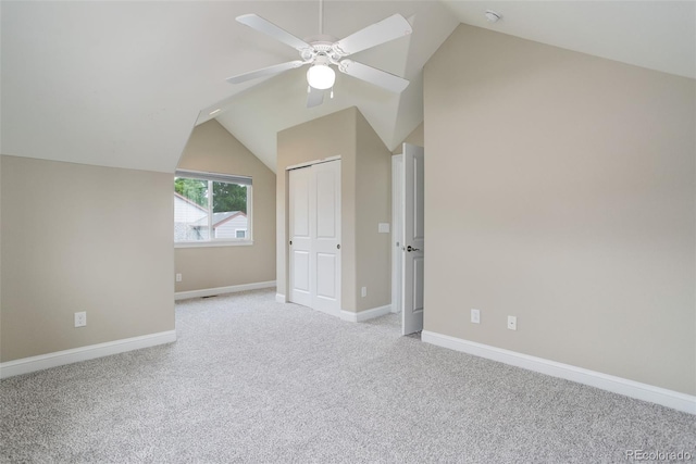 bonus room featuring ceiling fan, light colored carpet, and lofted ceiling