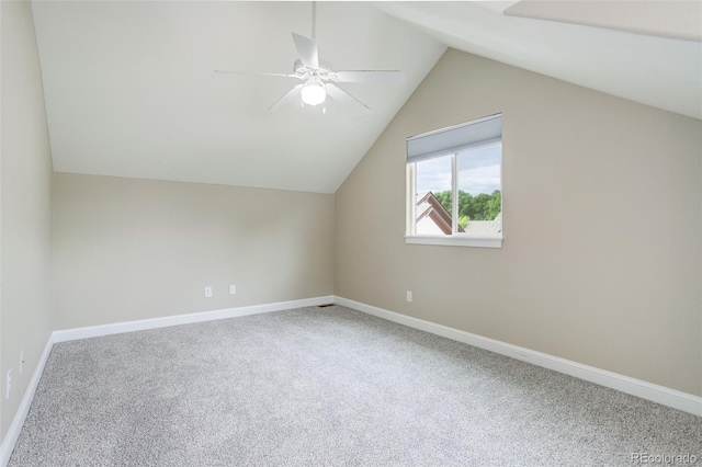 additional living space featuring vaulted ceiling, carpet floors, and ceiling fan