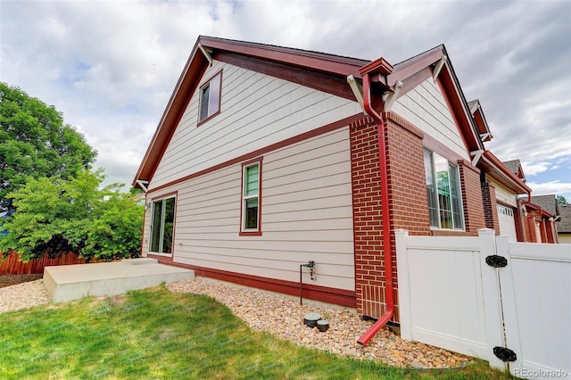 view of side of home with a yard