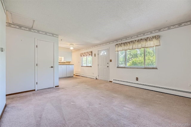 carpeted empty room featuring ceiling fan, a textured ceiling, and a baseboard radiator