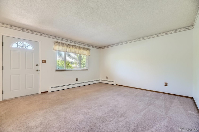 foyer featuring a baseboard heating unit, a textured ceiling, and light colored carpet