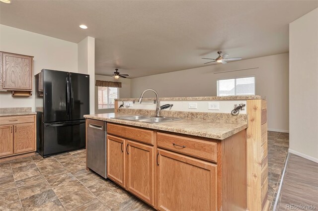 kitchen with dishwasher, black fridge, sink, and a wealth of natural light