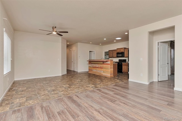 kitchen featuring plenty of natural light, ceiling fan, and black appliances