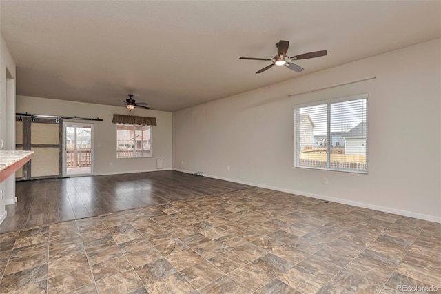 unfurnished living room featuring wood-type flooring and ceiling fan