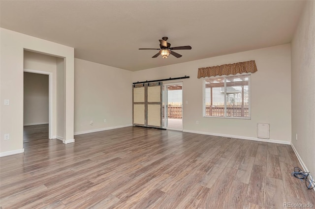 unfurnished room with hardwood / wood-style floors and ceiling fan