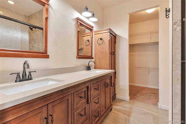 bathroom with tile patterned floors, vanity, and an enclosed shower