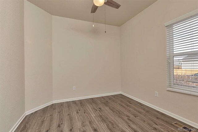 spare room with ceiling fan and wood-type flooring