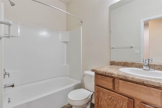 full bathroom featuring bathtub / shower combination, vanity, and toilet