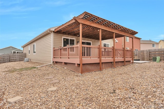 back of property featuring a pergola and a wooden deck