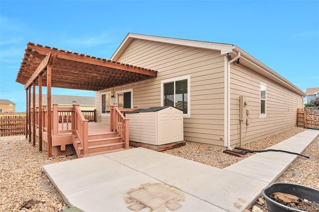 back of house featuring a patio area and a deck