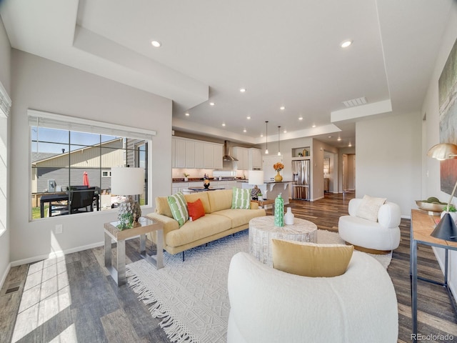 16448 E 111th Pl, Commerce City, CO 80022 - living area with a raised ceiling, dark wood finished floors, recessed lighting, and baseboards