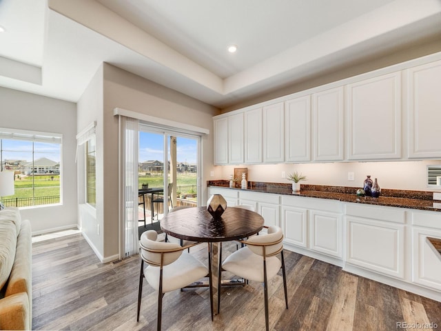 16448 E 111th Pl, Commerce City, CO 80022 - dining room featuring wood finished floors, a raised ceiling, recessed lighting, and baseboards