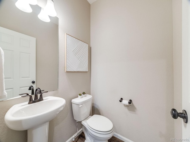 16448 E 111th Pl, Commerce City, CO 80022 - half bath with toilet, baseboards, and a sink