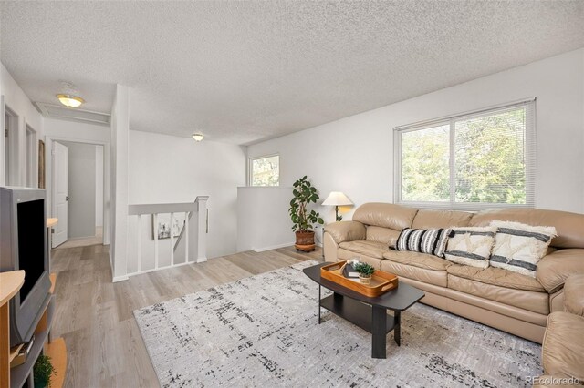 1245 Ceres Dr, Lafayette, CO 80026 - living area with a textured ceiling and light wood-style flooring
