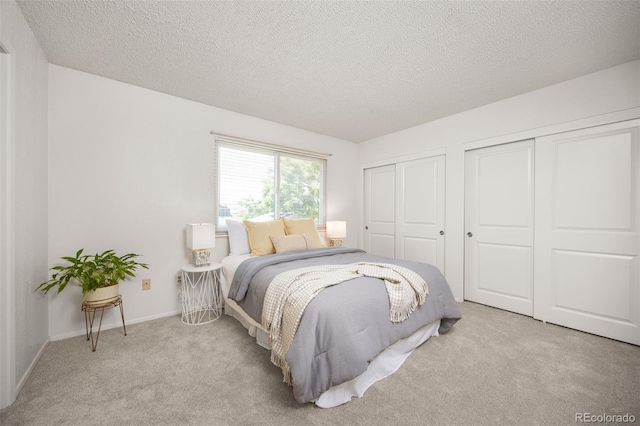 1245 Ceres Dr, Lafayette, CO 80026 - bedroom with multiple closets, carpet, and a textured ceiling