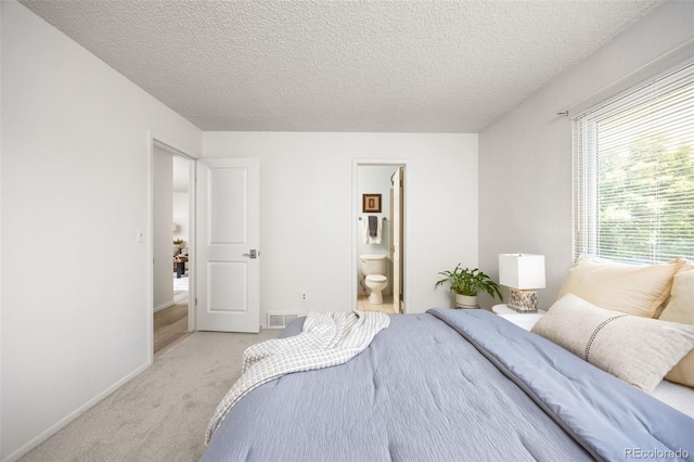 1245 Ceres Dr, Lafayette, CO 80026 - carpeted bedroom with a textured ceiling, connected bathroom, and baseboards