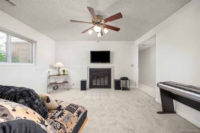 1245 Ceres Dr, Lafayette, CO 80026 - carpeted living room featuring a textured ceiling, ceiling fan, and a tile fireplace