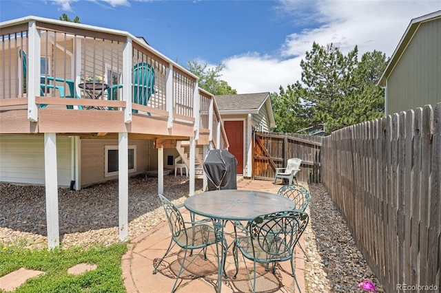 1245 Ceres Dr, Lafayette, CO 80026 - fenced backyard featuring a deck, outdoor dining space, a patio area, grilling area, and stairway
