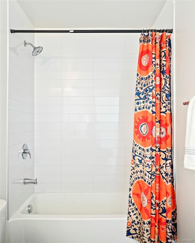 bathroom with toilet and shower / bath combo with shower curtain