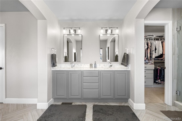 16207 Cadland Ct, Parker, CO 80134 - full bath featuring double vanity, a walk in closet, and an enclosed shower