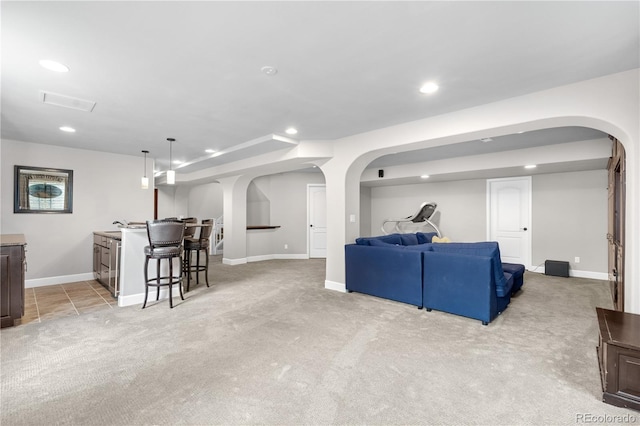 16207 Cadland Ct, Parker, CO 80134 - living area with arched walkways, light carpet, recessed lighting, and bar