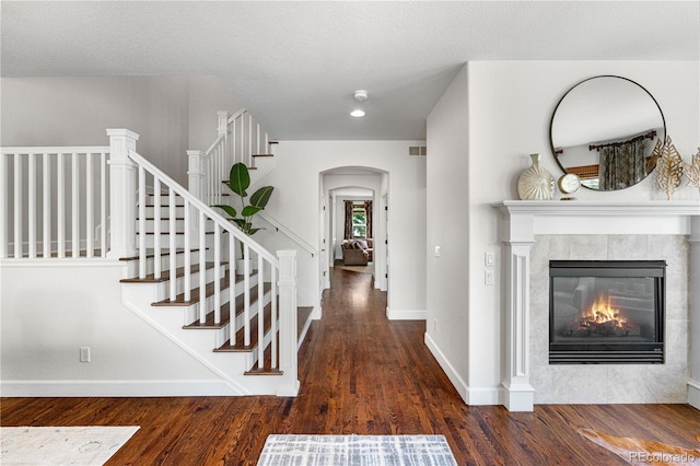 16207 Cadland Ct, Parker, CO 80134 - corridor with wood finished floors, arched walkways, and stairs