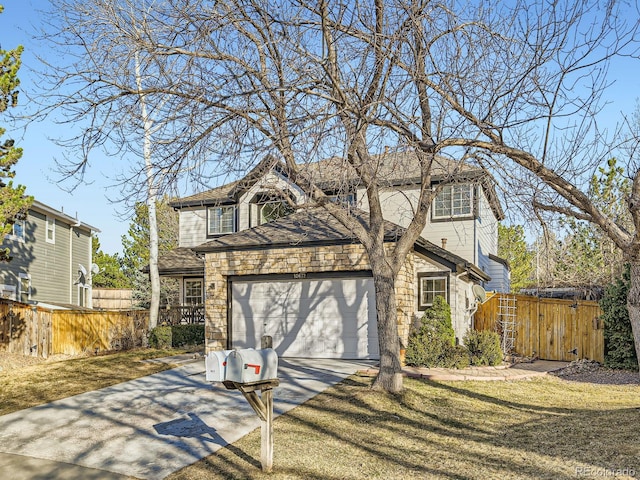 view of front of property with a front yard, fence, driveway, stone siding, and a garage